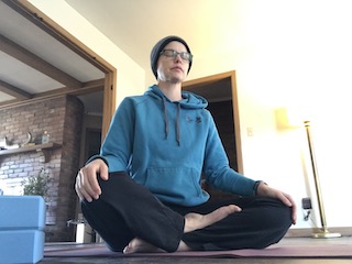 a person sits in meditation on the floor