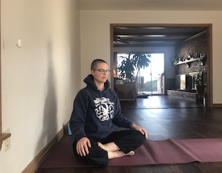 a person sits in meditation on the floor