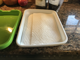 a green, plastic tray lined with paper towels