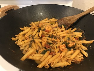 a pan filled with penne pasta covered with italian sauce