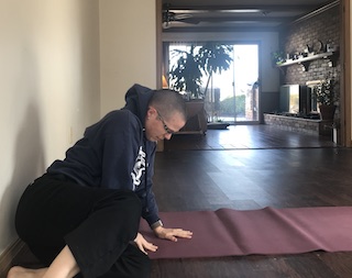 person lying on floor on one side, preparing to push up to seated position