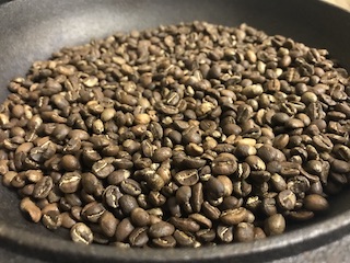 a pan of freshly roasted coffee beans