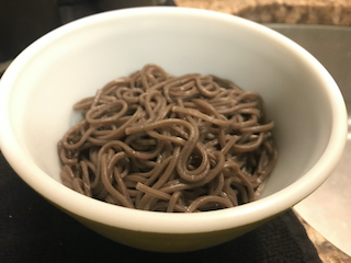 a bowl of cooked soba noodles