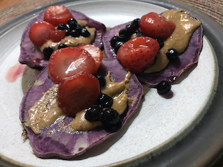 baked sweet potato slices with berries and syrup